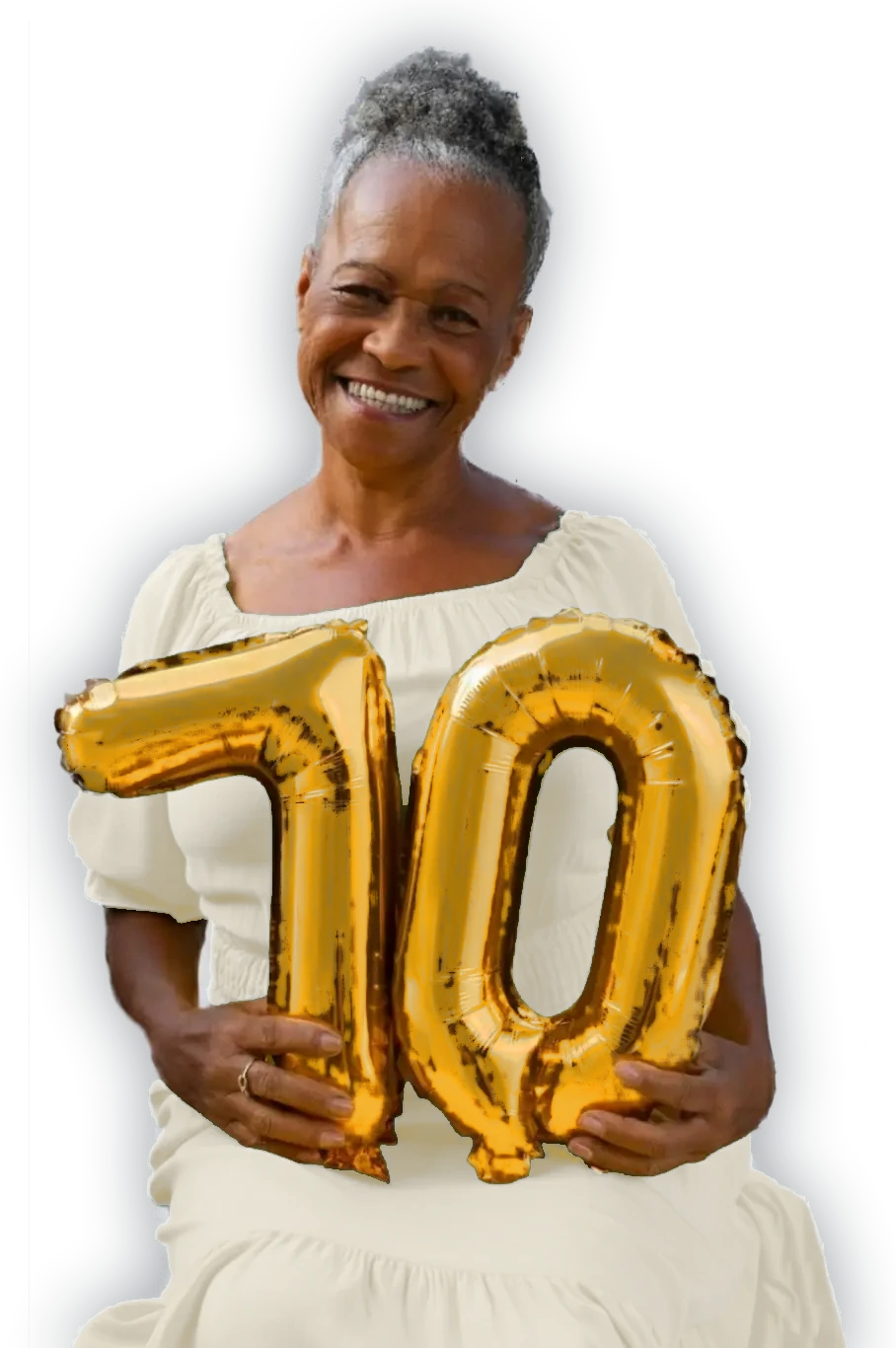 A smiling woman holding gold number-70 balloons