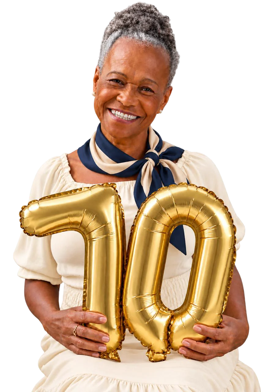 A smiling woman in a navy scarf holding gold number-70 balloons
